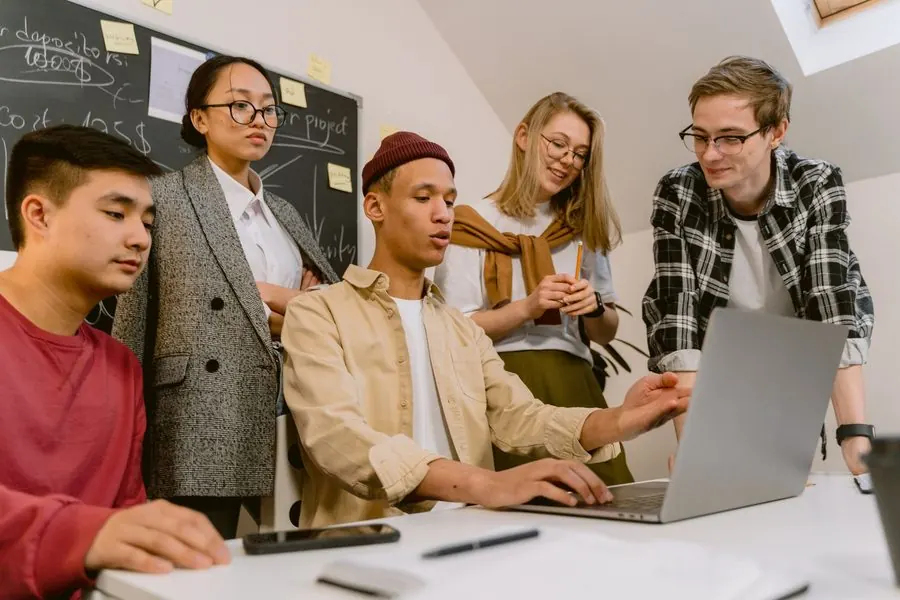 Young startup team working around a laptop